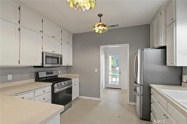 a kitchen with stainless steel appliances a refrigerator a stove a sink and dishwasher