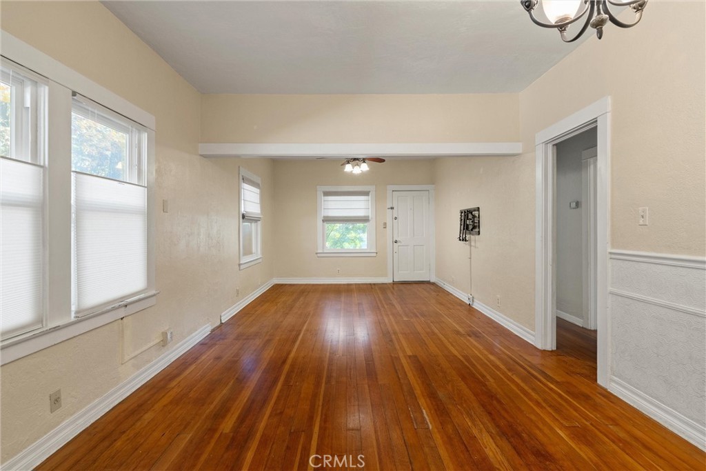 1158 East 7th Street Chico, CA 95928 - Photo 8 of 41 a view of an empty room with wooden floor and a window