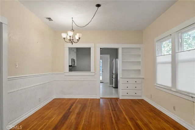 a view of a room with wooden floor and window