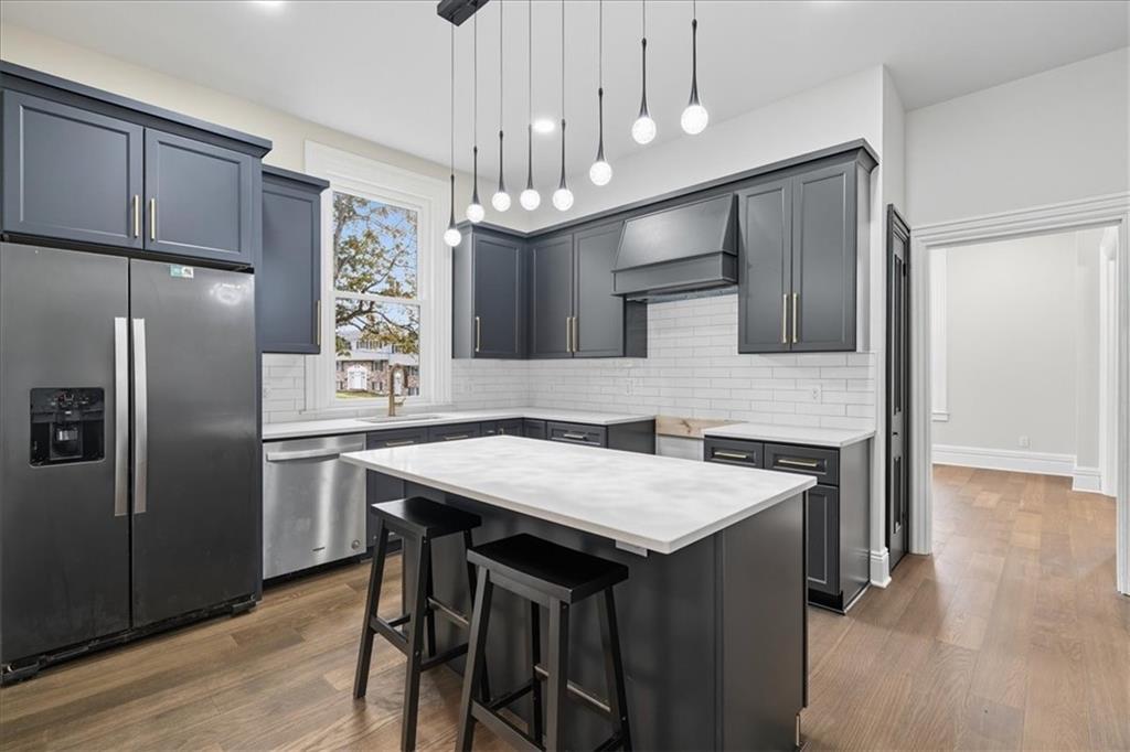 205 Spring Street Oakdale, PA 15071 - Photo 12 of 50 a kitchen with a table chairs refrigerator and microwave