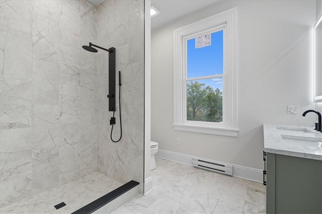 205 Spring Street Oakdale, PA 15071 - Photo 28 of 50 a bathroom with a granite countertop sink a mirror and shower