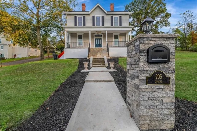 a front view of a house with garden