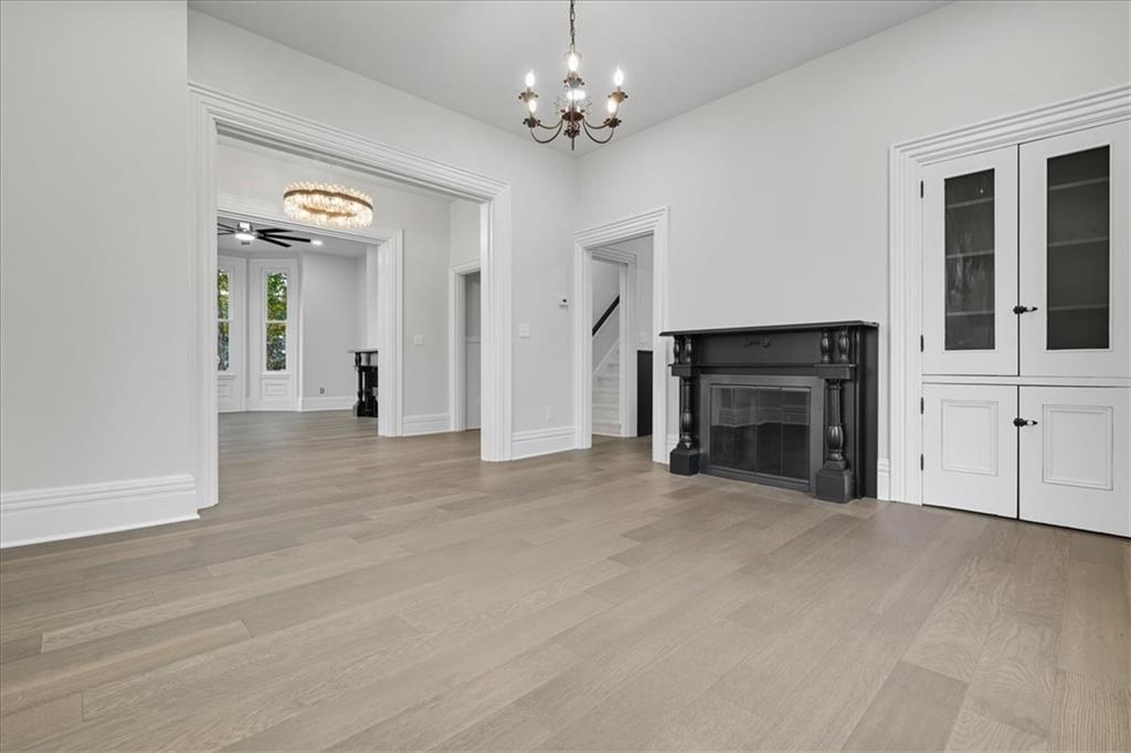 205 Spring Street Oakdale, PA 15071 - Photo 8 of 50 a view of a livingroom with a fireplace a chandelier and windows