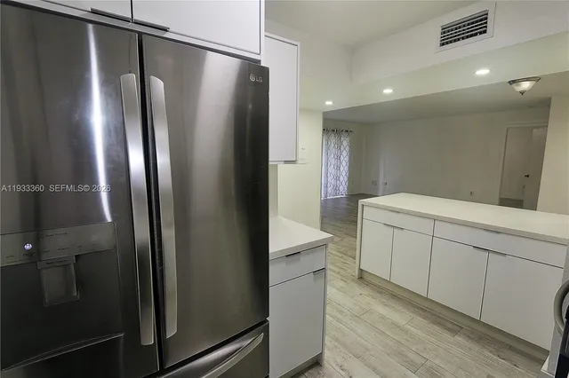 a kitchen with a refrigerator and a sink