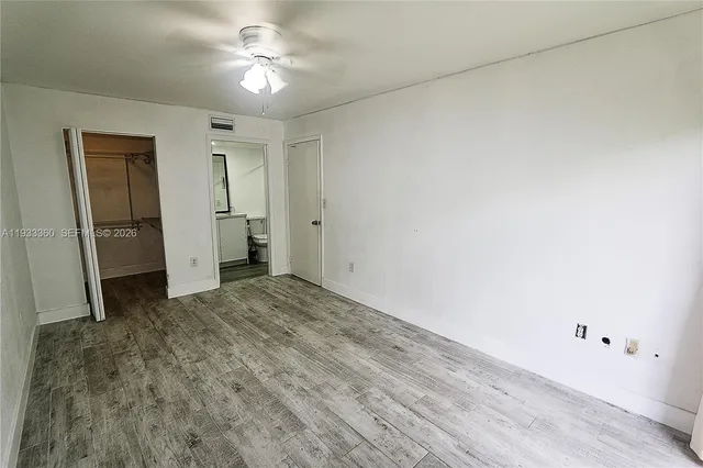 a view of empty room with ceiling fan