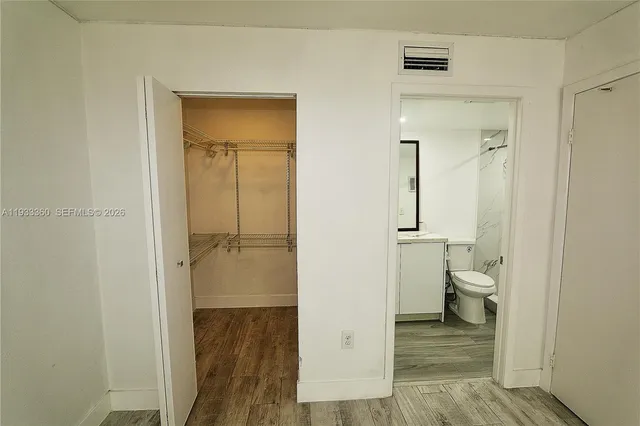 a bathroom with a granite countertop toilet and a shower