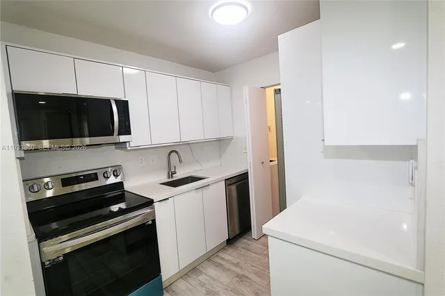 a view of a kitchen with electric appliances