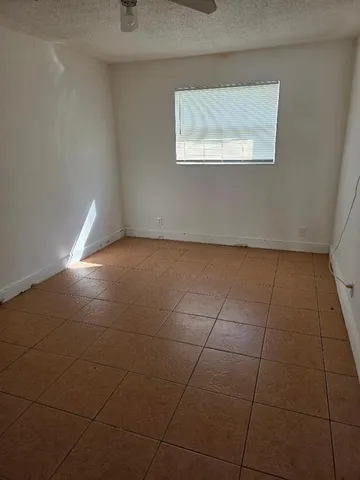 a view of a kitchen with an empty space and a window