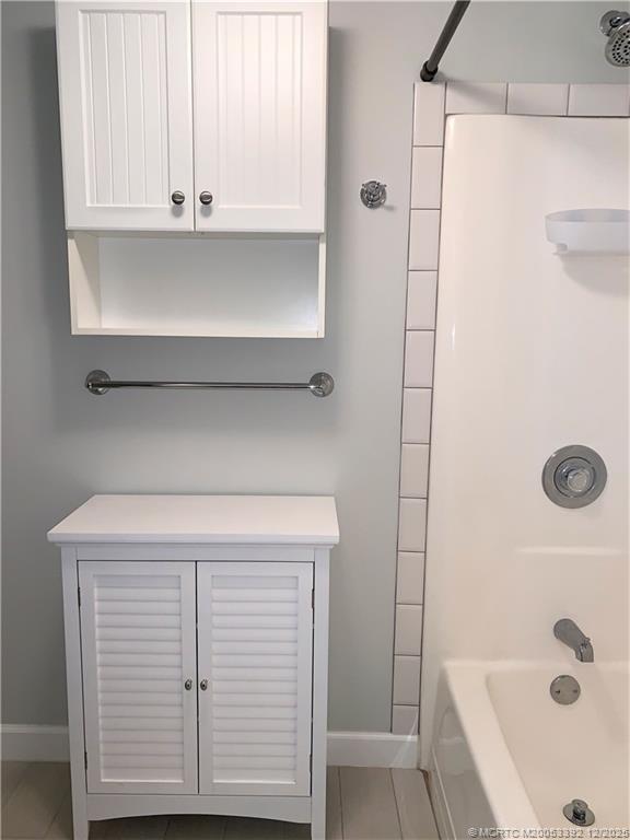 3302 Southeast Aster Lane Stuart, FL 34994 - Photo 13 of 19 a bathroom with a bathtub and a shower