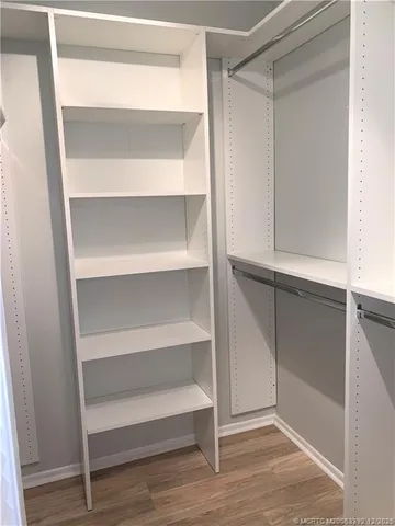 a view of walk in closet with empty racks