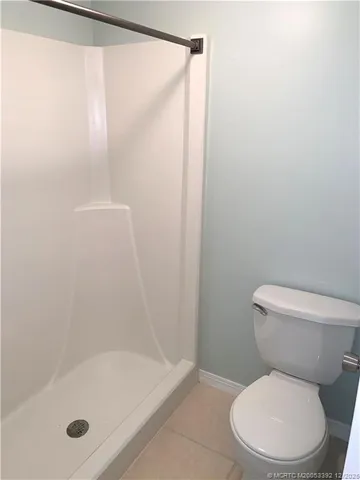 a white toilet sitting next to a bath tub