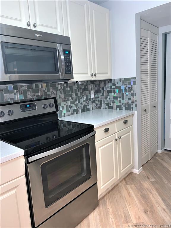 3302 Southeast Aster Lane Stuart, FL 34994 - Photo 8 of 19 a stove top oven sitting inside of a kitchen