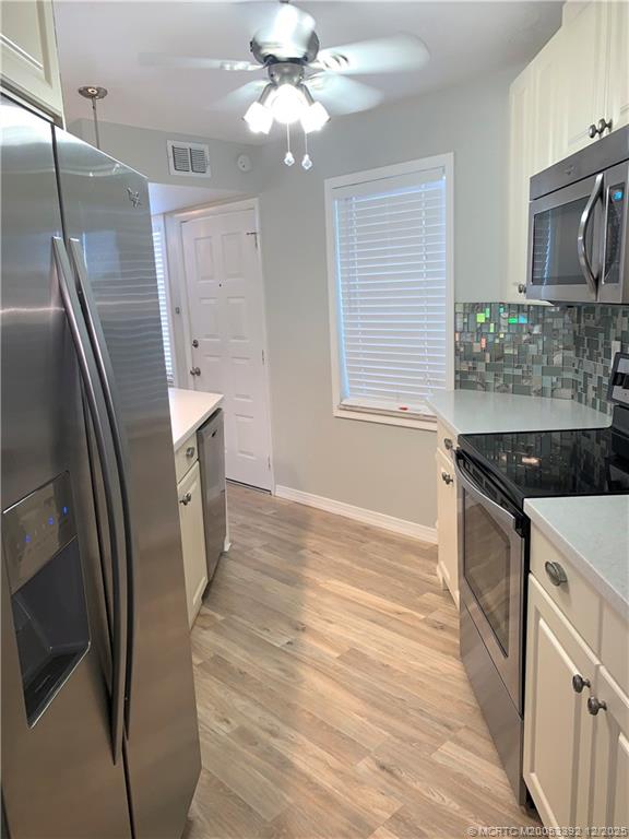 3302 Southeast Aster Lane Stuart, FL 34994 - Photo 9 of 19 a kitchen with stainless steel appliances granite countertop a refrigerator a stove a sink and a refrigerator