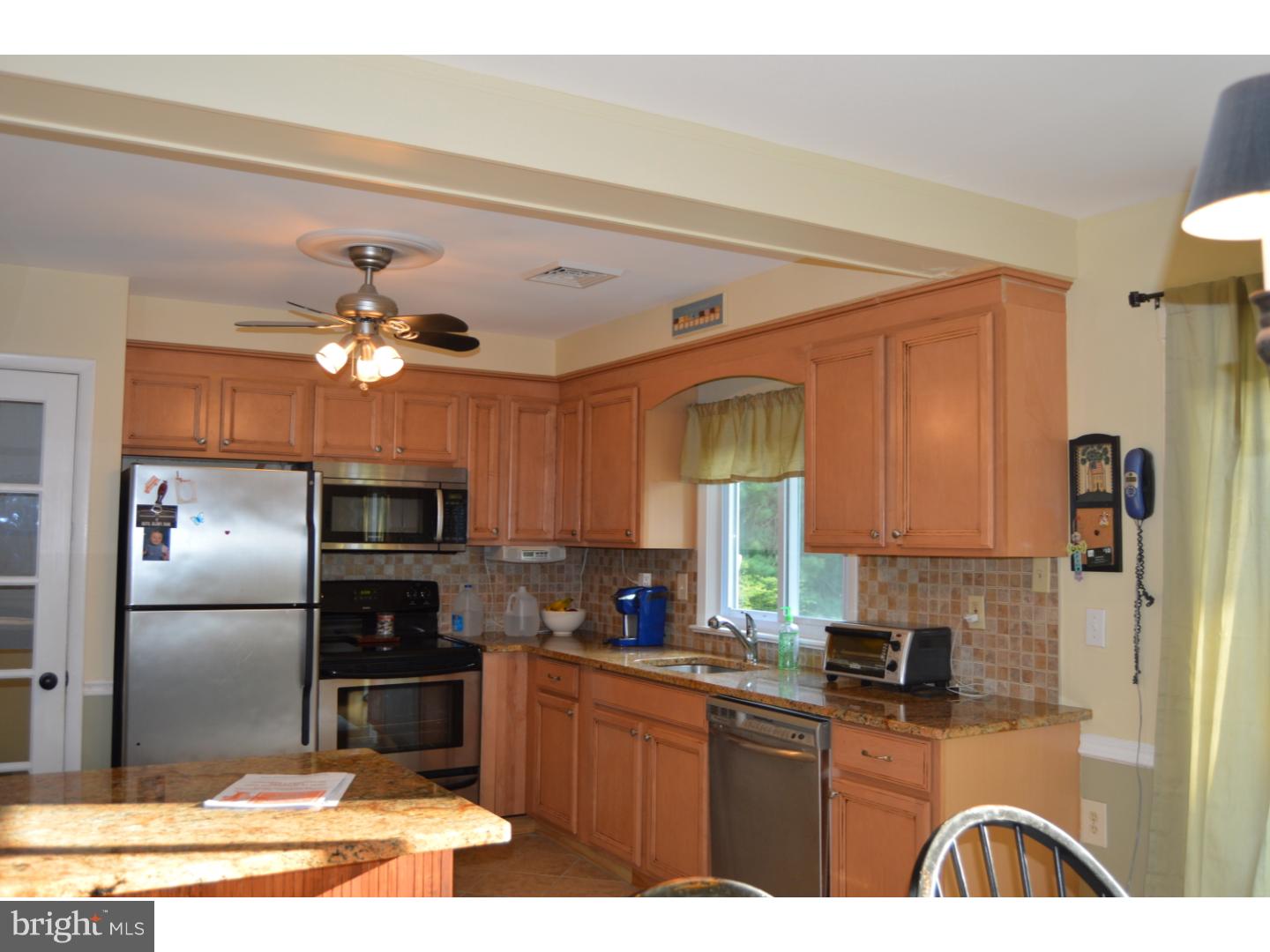 16 Dublin Road Pennington, NJ 08534 - Photo 4 of 19 a kitchen with kitchen island granite countertop stainless steel appliances and a refrigerator