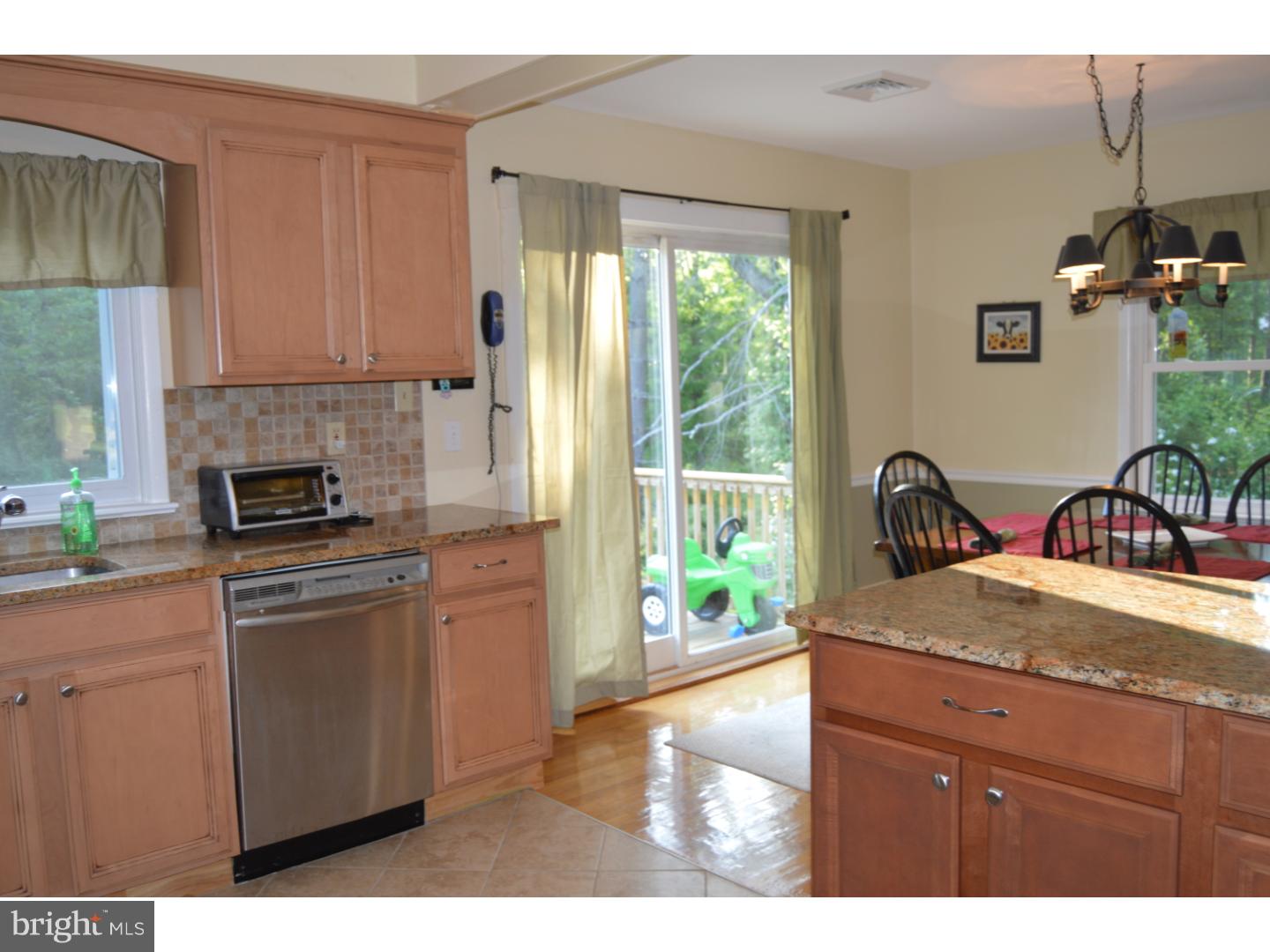 16 Dublin Road Pennington, NJ 08534 - Photo 5 of 19 a kitchen with a stove a sink and a refrigerator