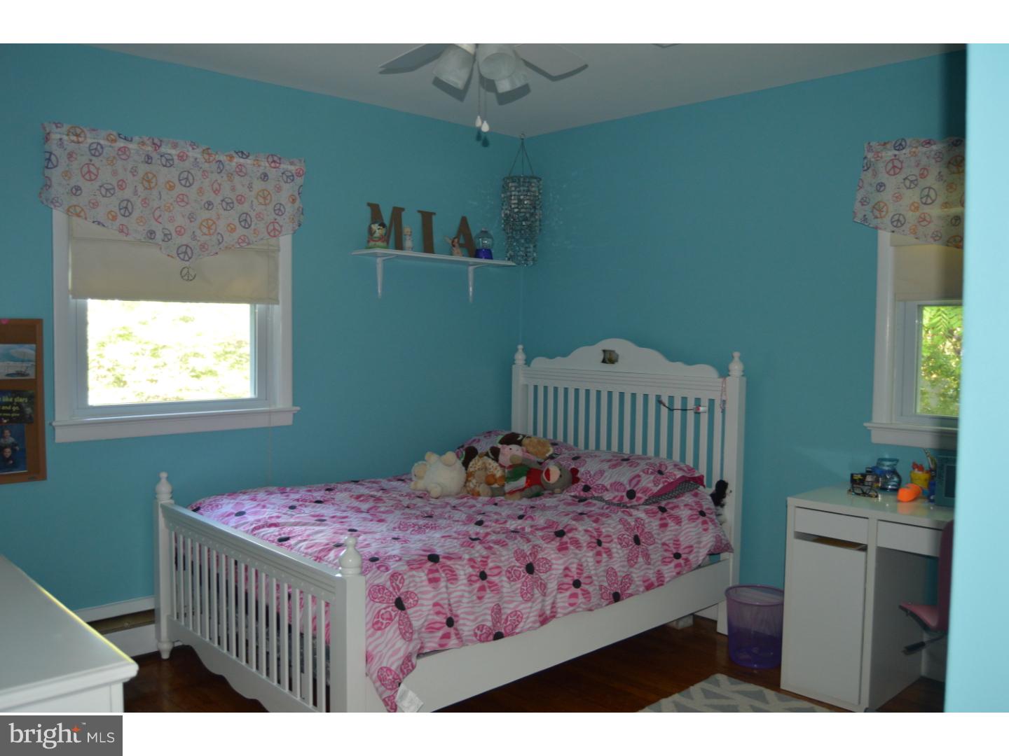 16 Dublin Road Pennington, NJ 08534 - Photo 8 of 19 a bedroom with a bed and a table in it