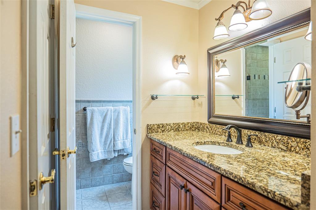 741 Brookside Road Maitland, FL 32751 - Photo 29 of 43 a bathroom with a granite countertop sink and a mirror