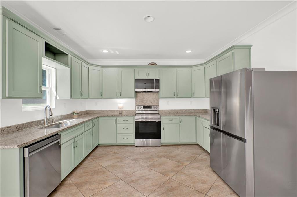 2794 Cleburne Parkway Powder Springs, GA 30127 - Photo 17 of 49 a kitchen with a refrigerator sink and stove