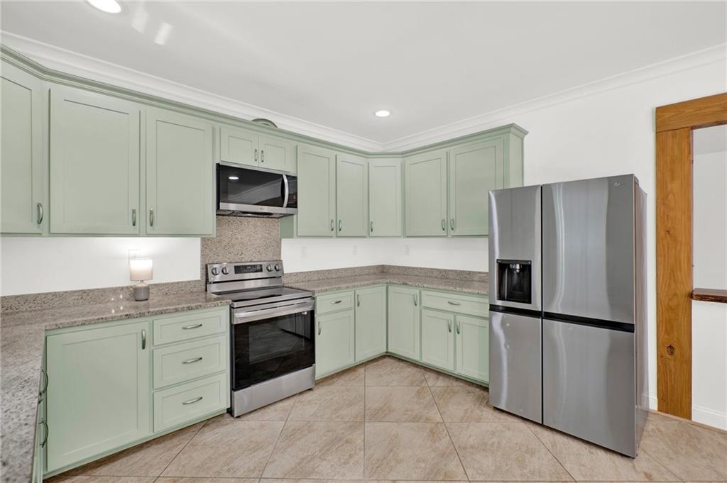 2794 Cleburne Parkway Powder Springs, GA 30127 - Photo 18 of 49 a kitchen with a refrigerator sink and cabinets