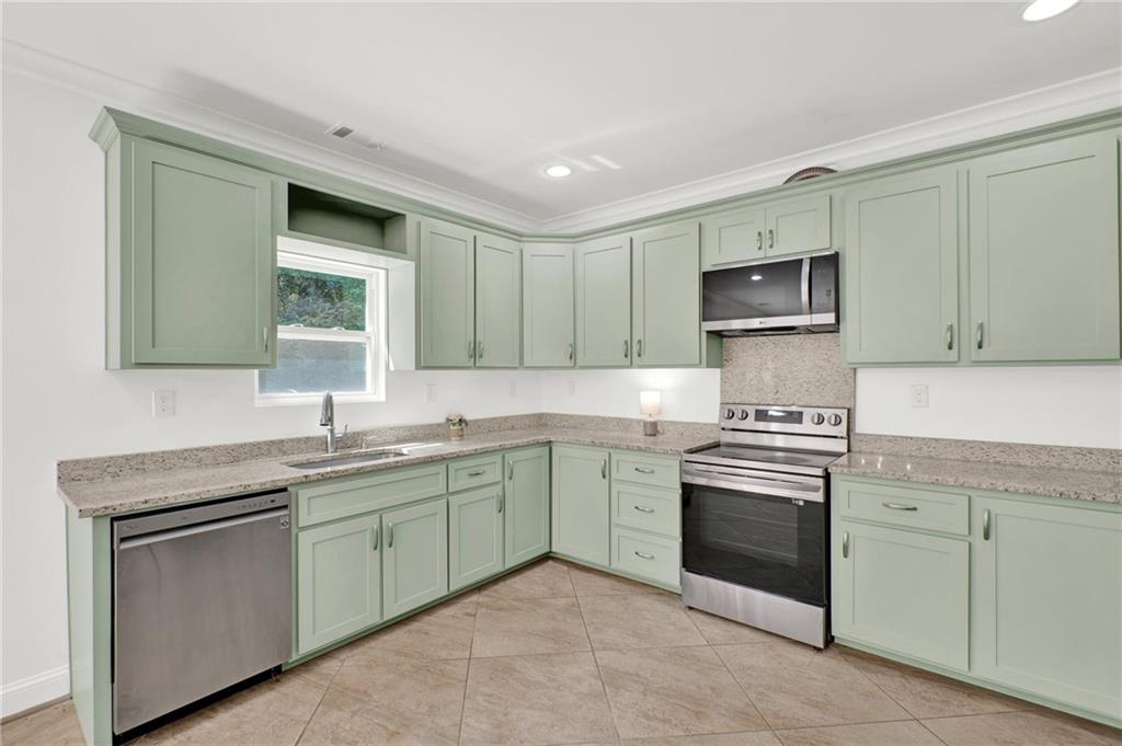 2794 Cleburne Parkway Powder Springs, GA 30127 - Photo 19 of 49 a kitchen with a sink stove and cabinets