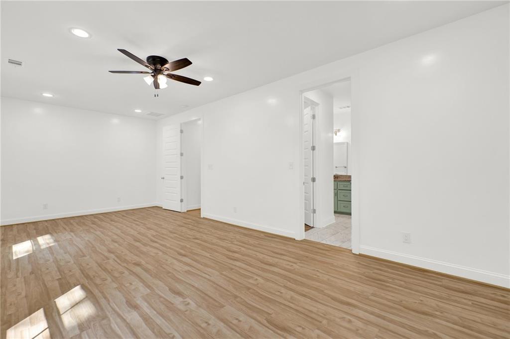 2794 Cleburne Parkway Powder Springs, GA 30127 - Photo 23 of 49 an empty room with wooden floor and windows