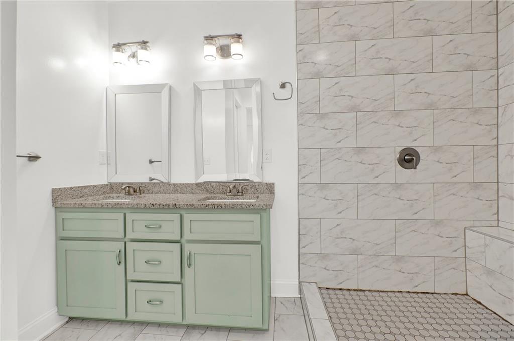 2794 Cleburne Parkway Powder Springs, GA 30127 - Photo 25 of 49 a bathroom with a granite countertop sink and a mirror