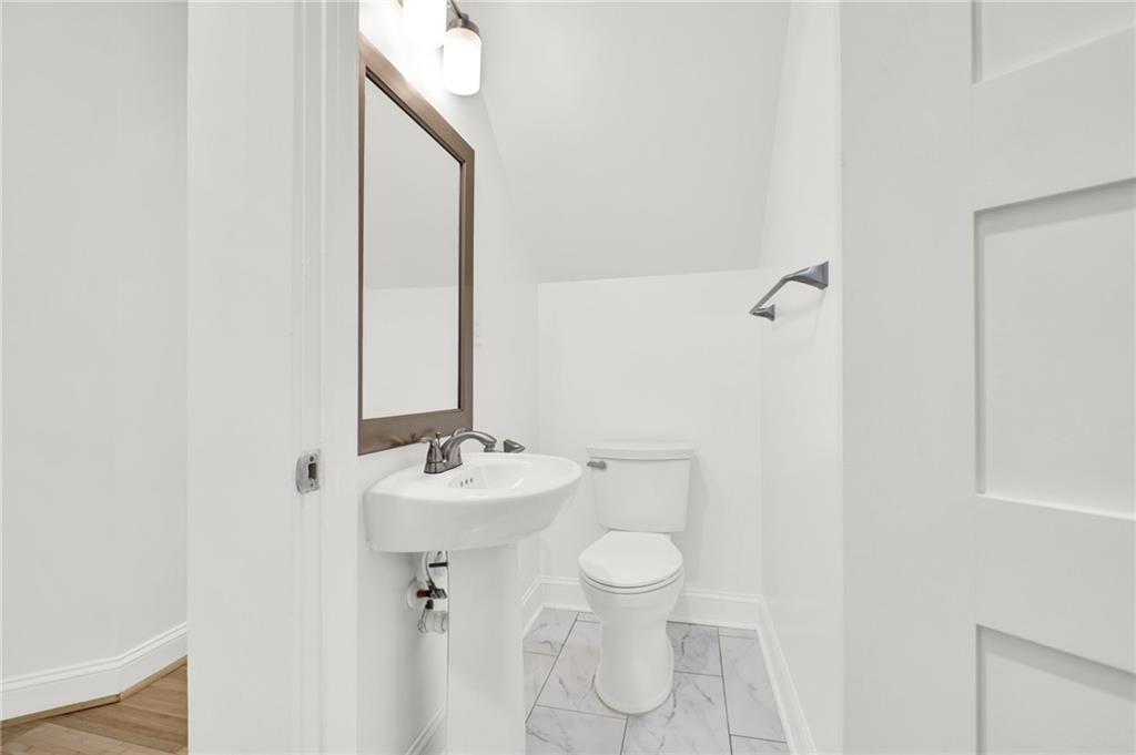 2794 Cleburne Parkway Powder Springs, GA 30127 - Photo 27 of 49 a bathroom with a sink mirror and toilet