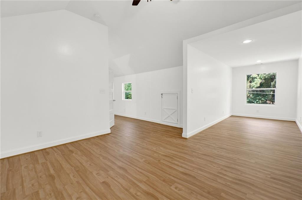 2794 Cleburne Parkway Powder Springs, GA 30127 - Photo 35 of 49 an empty room with wooden floor and windows
