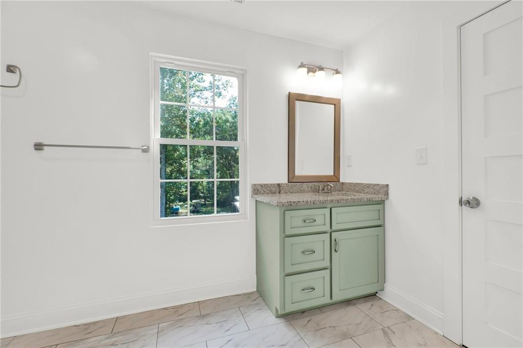 2794 Cleburne Parkway Powder Springs, GA 30127 - Photo 38 of 49 an empty room with mirror and window