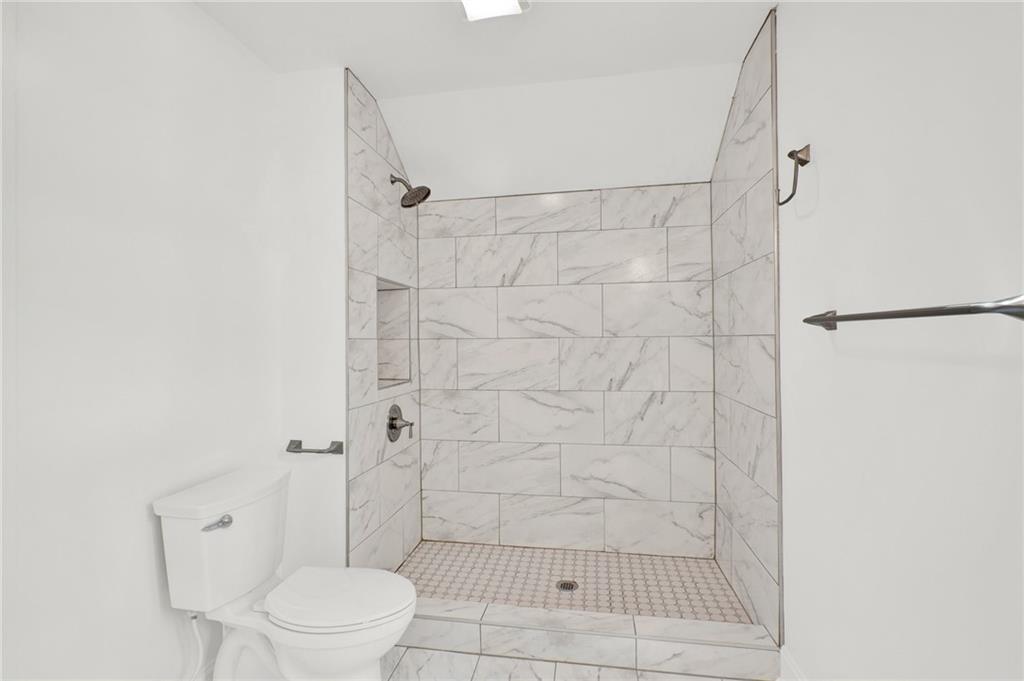 2794 Cleburne Parkway Powder Springs, GA 30127 - Photo 39 of 49 a bathroom with a shower and a toilet