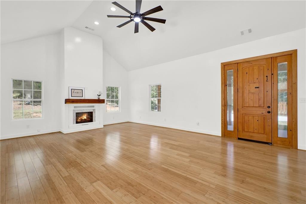 2794 Cleburne Parkway Powder Springs, GA 30127 - Photo 8 of 49 an empty room with wooden floor cabinet and windows