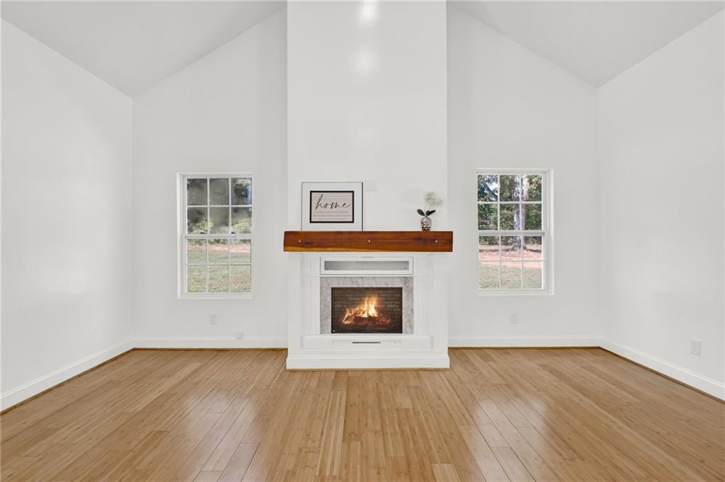 2794 Cleburne Parkway Powder Springs, GA 30127 - Photo 10 of 49 a living room with wooden floor and a fireplace