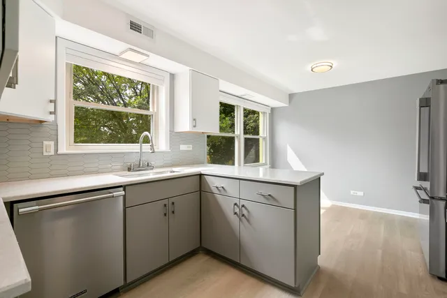 a kitchen with a sink and large window