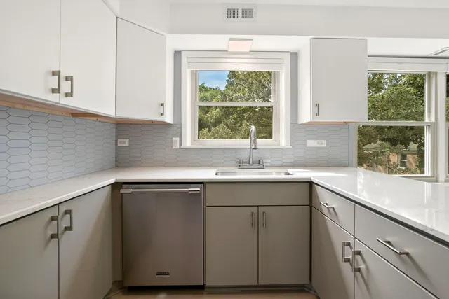 a kitchen with a sink and large window