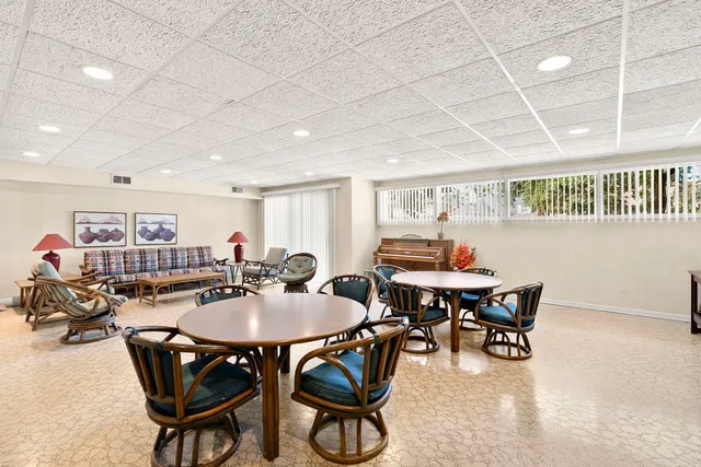 a dining room with furniture and a livingroom view