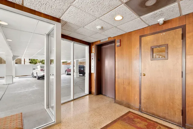 a view of a hallway with wooden shelves