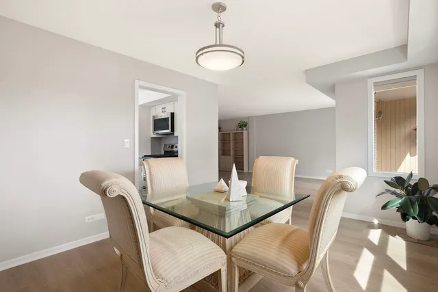 a view of a dining room with furniture and wooden floor