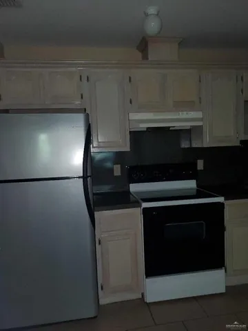 a stove top oven sitting inside of a kitchen