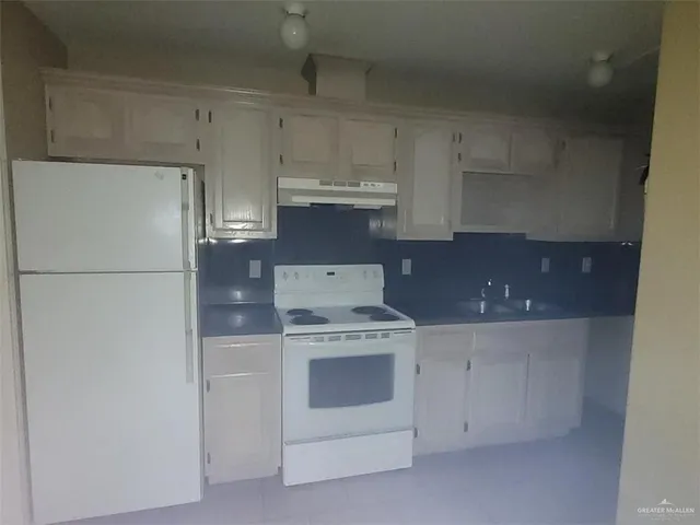 a stove top oven sitting inside of a kitchen