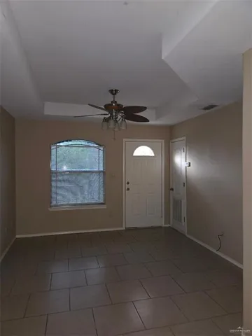 an empty room with a empty space and windows