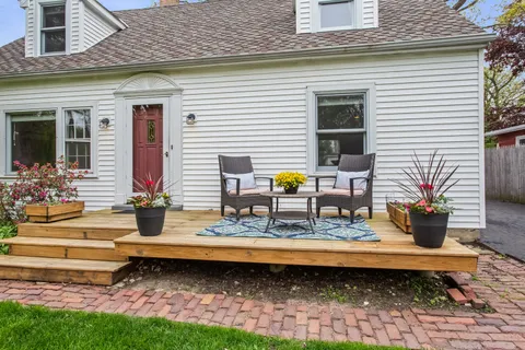 a view of a house with backyard and sitting area