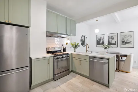 a kitchen with a sink stainless steel appliances and cabinets