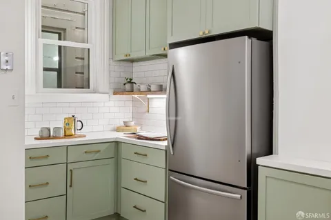 a white refrigerator freezer sitting inside of a kitchen