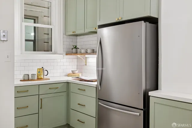 a white refrigerator freezer sitting inside of a kitchen