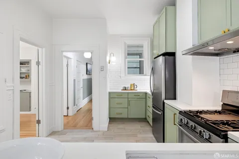a kitchen with a refrigerator and a stove