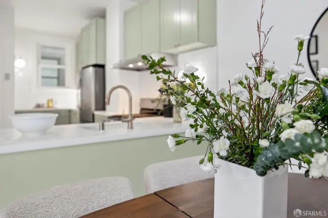 a bathroom with a sink a mirror and a potted plant