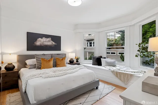 a bedroom with a large bed and a flat screen tv