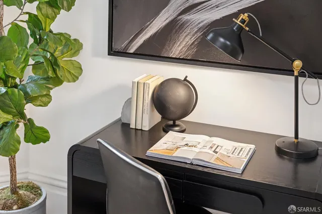 a living room with furniture and a potted plant