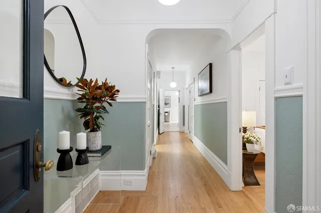 a view of a hallway with wooden floor and entryway