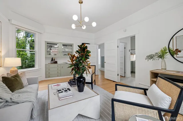 a living room with furniture potted plant and window